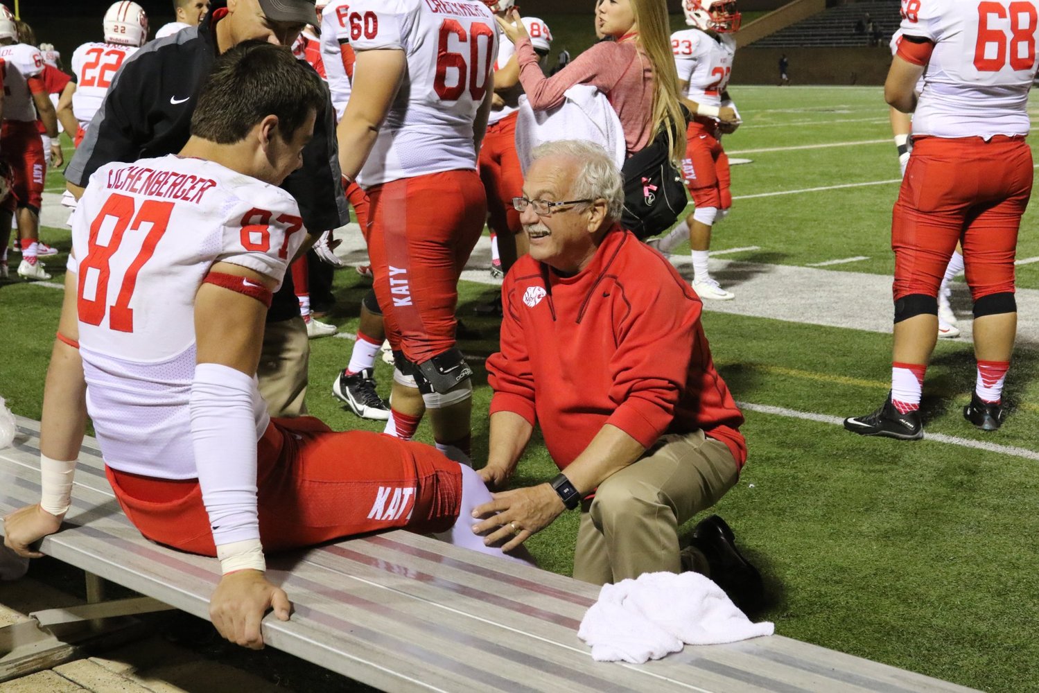 Dr. Mark Bing is pictured treating former Katy High tight end Parker Eichenberger during a high school football game. Dr. Bing served as the team doctor for Katy High for many decades. He died Jan. 9.